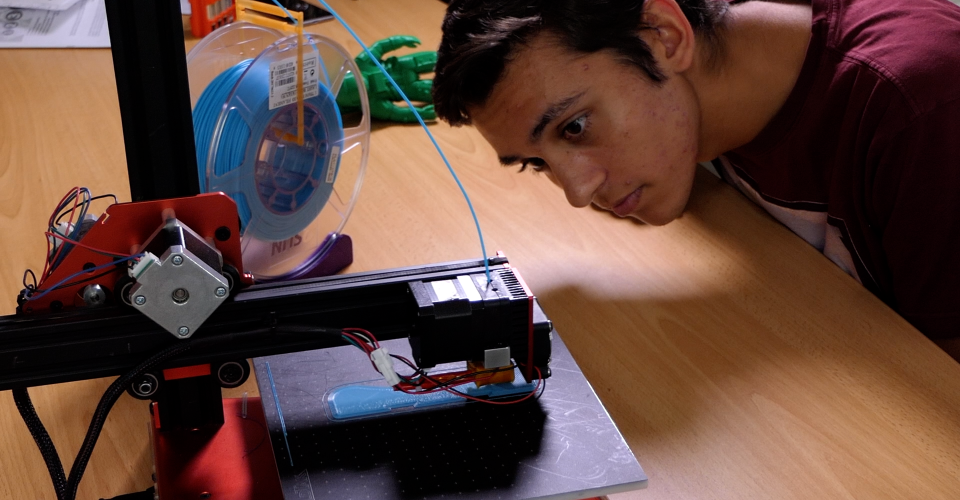 Student working with 3D printer