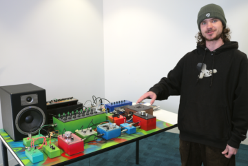 Student points at home-made synthesiser