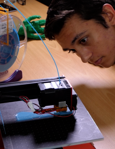Student working with 3D printer