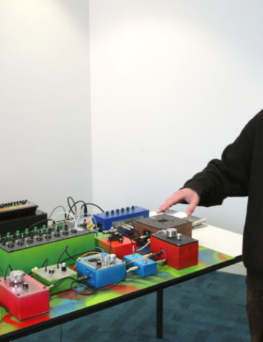 Student points at home-made synthesiser