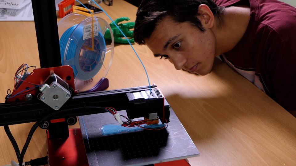 Student working with 3D printer