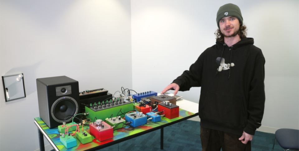 Student points at home-made synthesiser